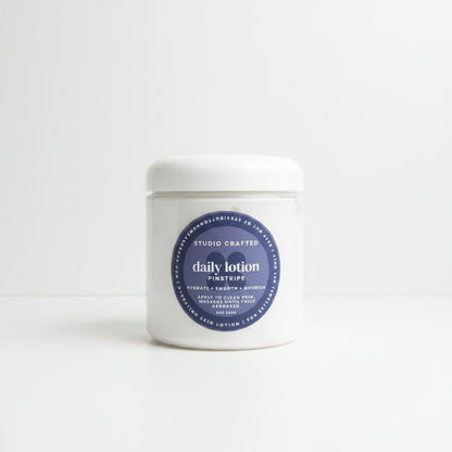 jar of daily lotion in pinstripe men's edit fragrance. 