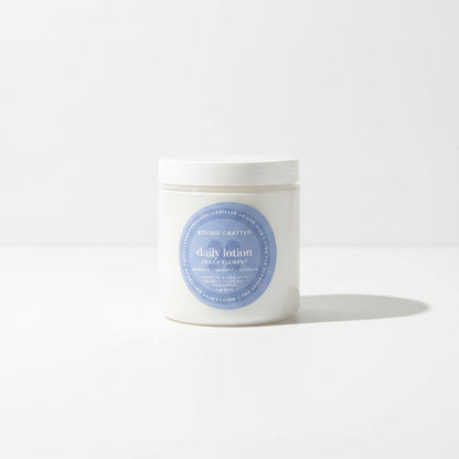 a white jar of daily lotion in trace element fragrance for everyday use.