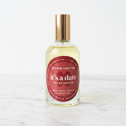 Glass perfume bottle with gold cap sticky sweet warm vanilla date fragrance