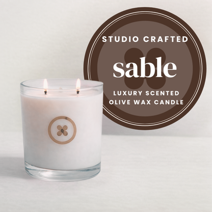Studio Crafted sable luxury scented olive wax candle with a brown label on a light background